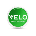 Velo Bright Spearmint nicotine pouch in a green circular container.