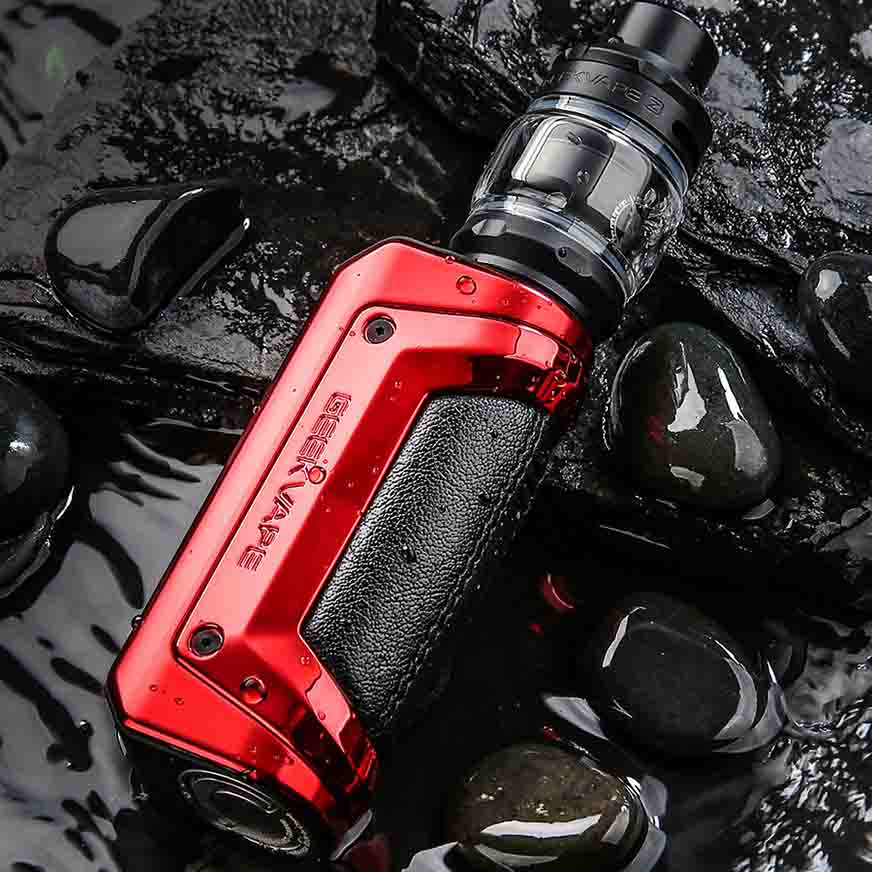 Red GeekVape Aegis Solo mod resting on wet stones, showcasing a rugged and waterproof design for vaping enthusiasts.