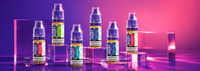 Neon lit e-liquids display with Lost Mary nic salt bottles in multiple flavours arranged on clear blocks.